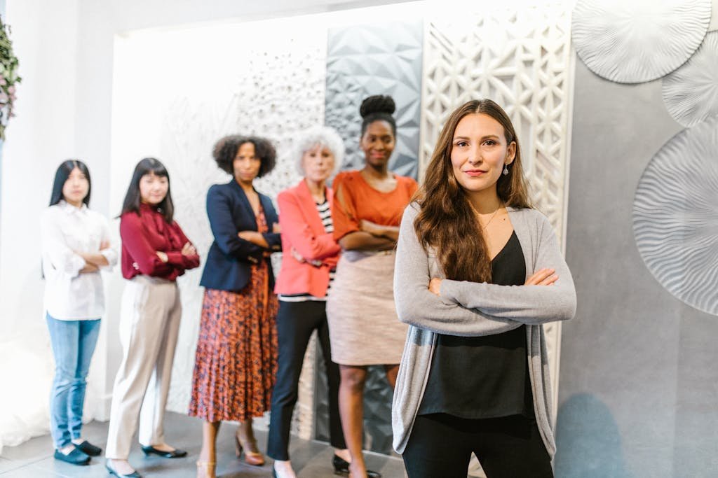 A group of diverse businesswomen standing confidently in a modern office environment.