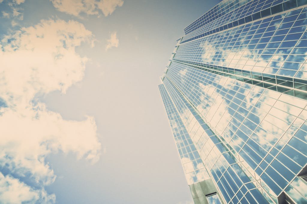 A stunning skyscraper in London, Ontario reflecting clouds on its glass facade.